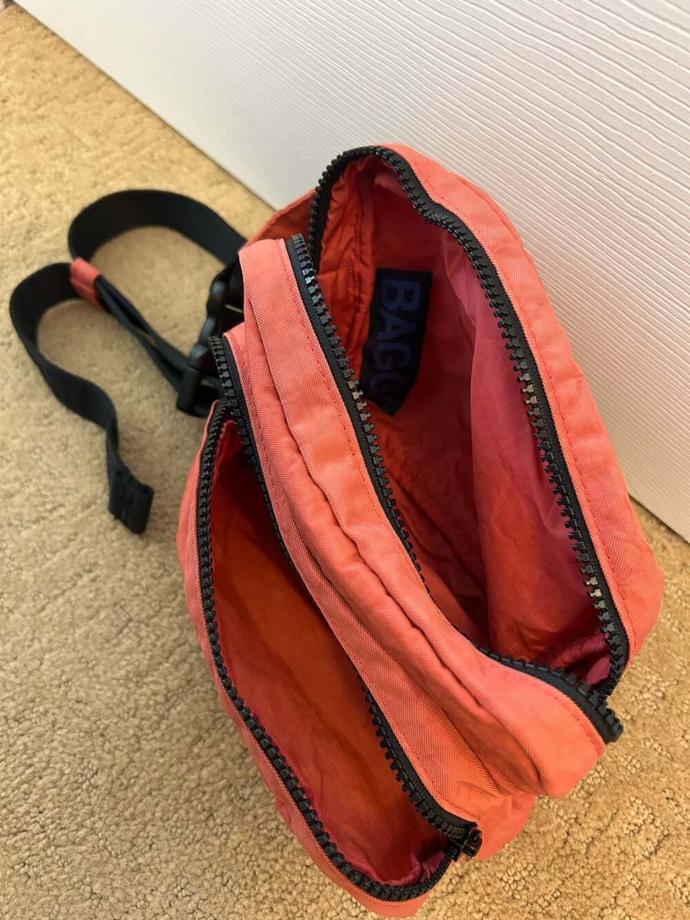 BAGGU Fanny Pack Nylon Crescent Crossbody Bag in a Coral Salmon Color